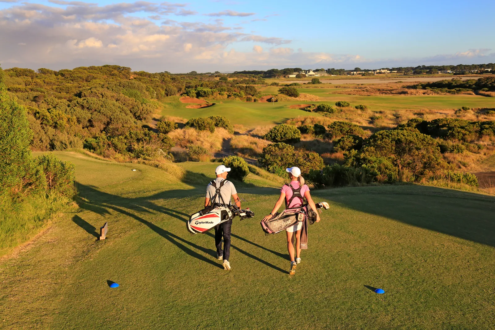 Two golfers walking off the 7th tee at 13th Beach Golf Links