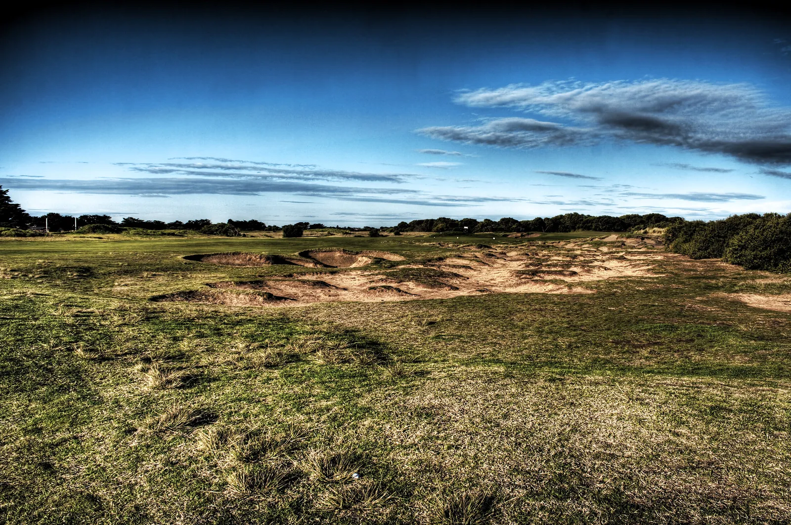 Links fairway with rugged sand bunkers under a blue sky at Barwon Heads