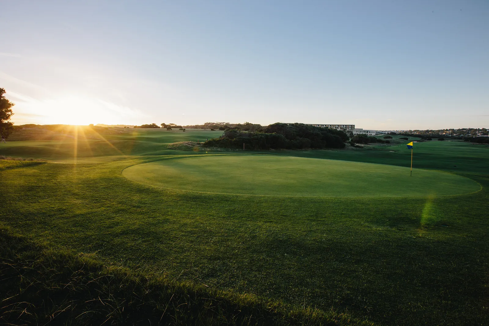 The sun setting over a green at RACV Torquay Golf Club