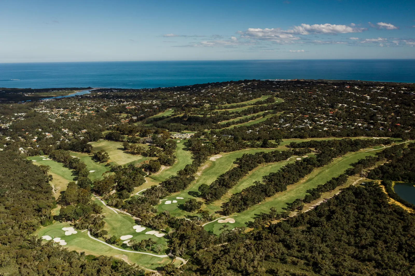 Aerial view of Anglesea Golf Club with the sea behind