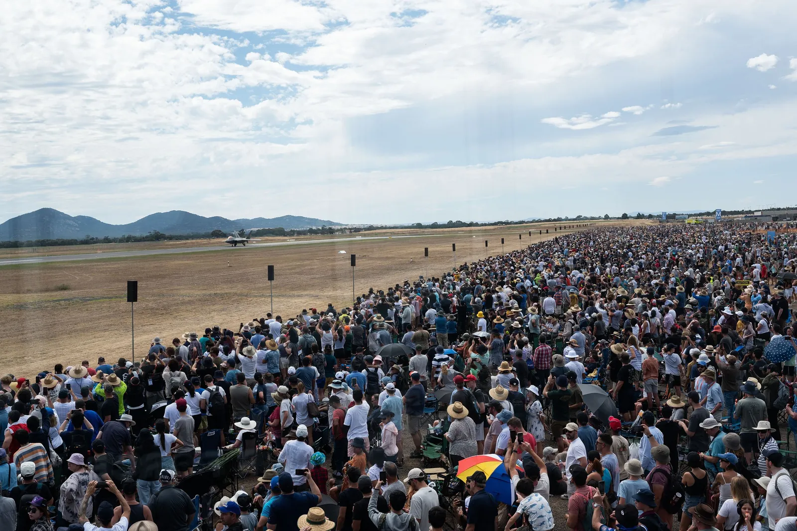 Huge crowds lining the flight line at the 2023 Avalon Airshow, with the You Yangs behind