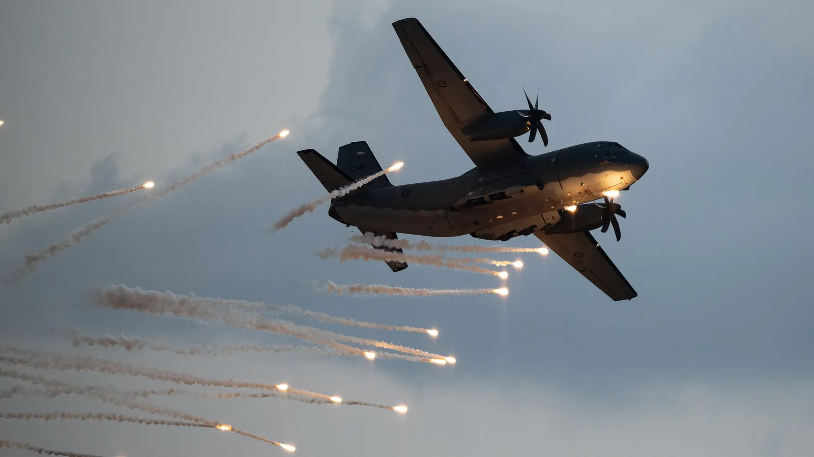 A RAAF C-27J Spartan firing flares during a flying display at the 2025 Avalon Airshow