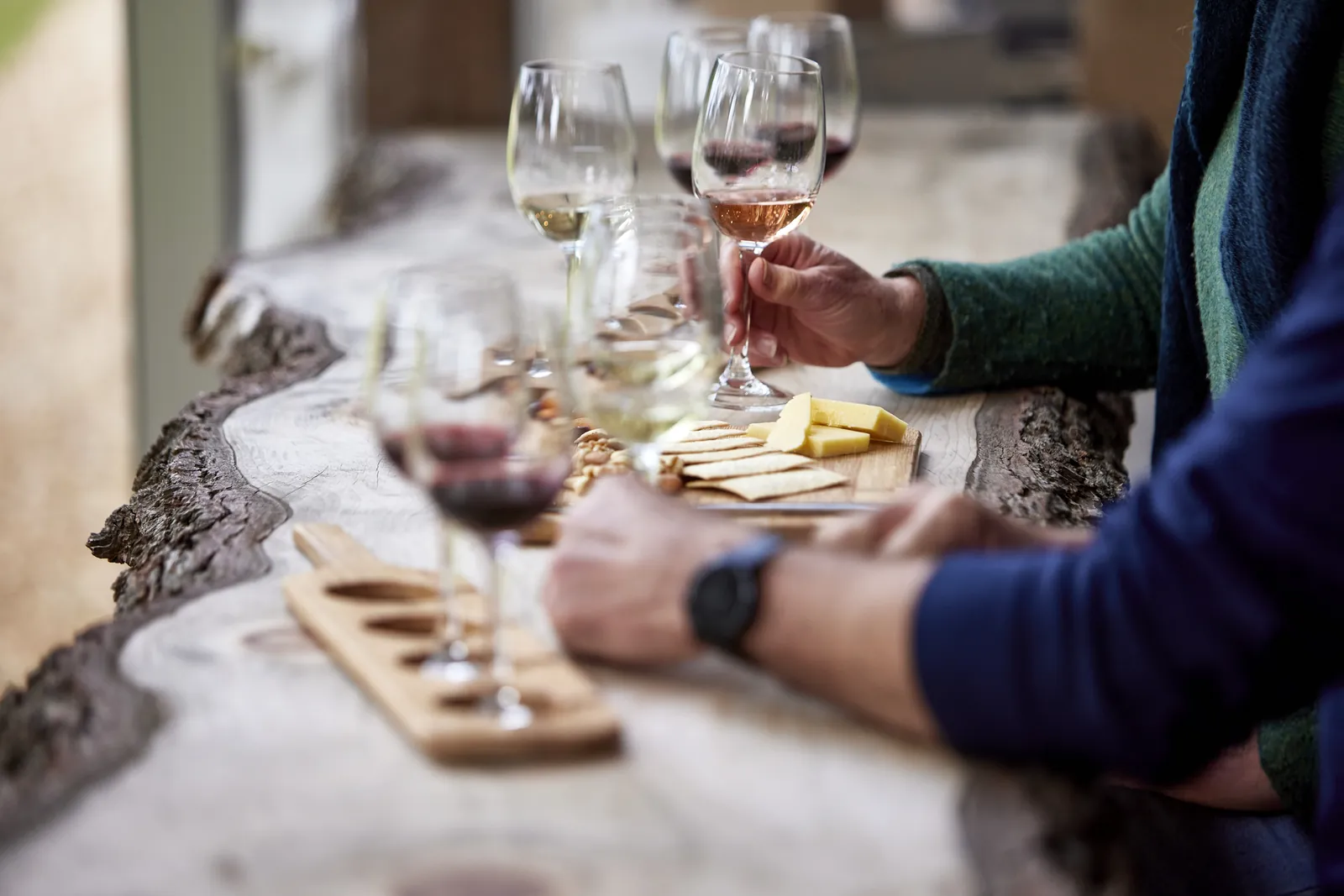 A tasting flight of white and red wines on a timber bench at Bellbrae Estate