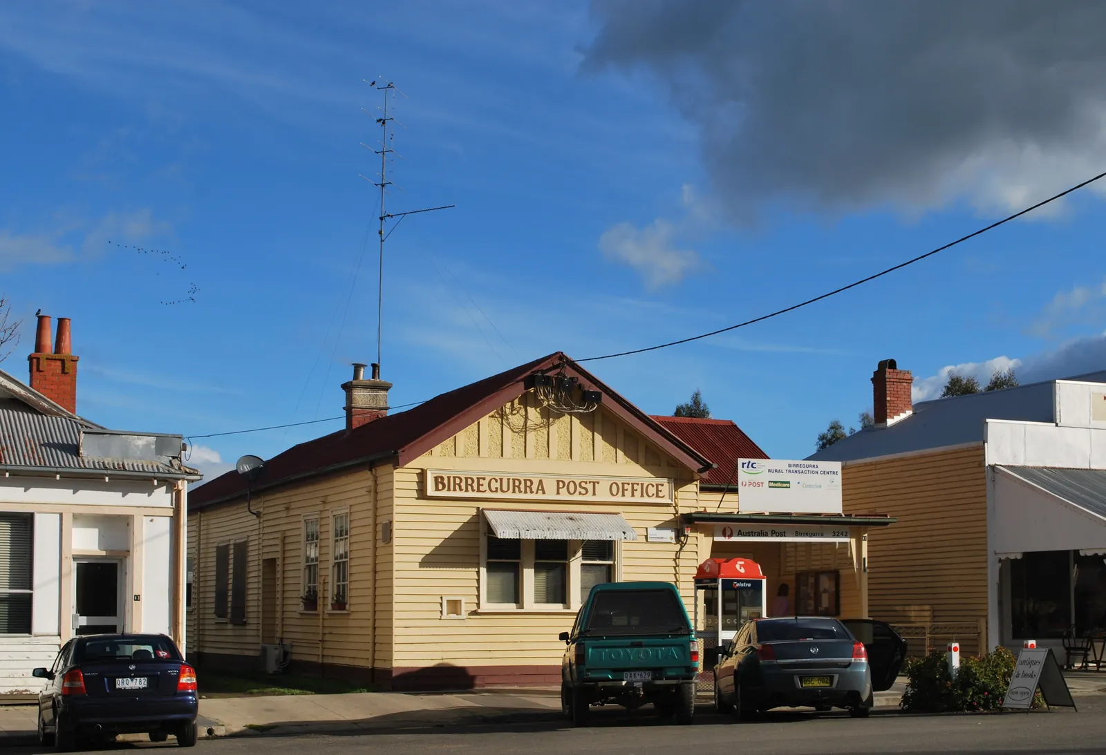 The cream weatherboard Birregurra Post Office with a red roof, on Main Street