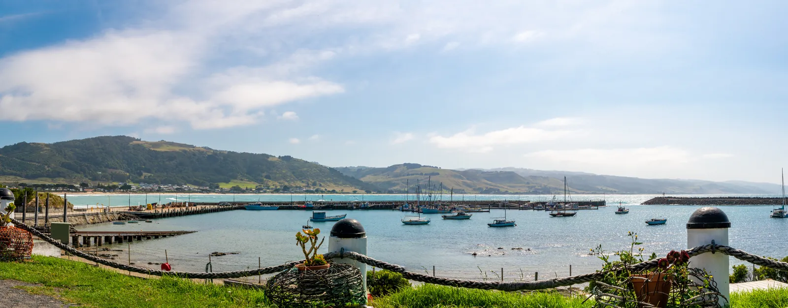 Wide view over Apollo Bay, its curved shoreline and the hills behind town