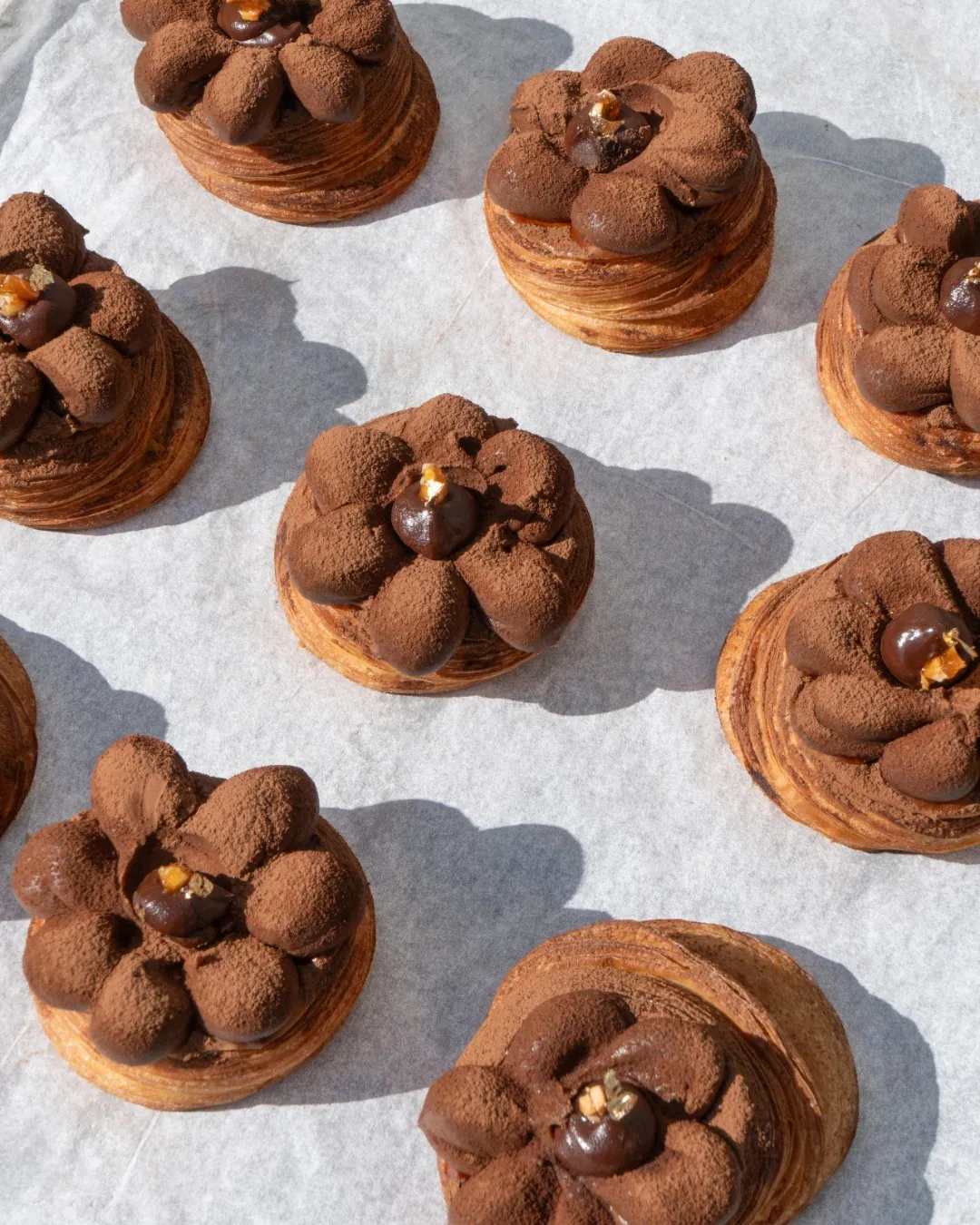 Chocolate pastries laid out on baking paper at Charlie Bakery
