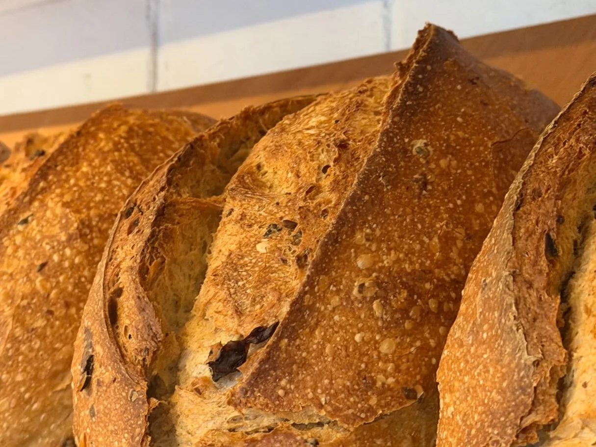 Sourdough loaves on a timber shelf at Charlie Bakery