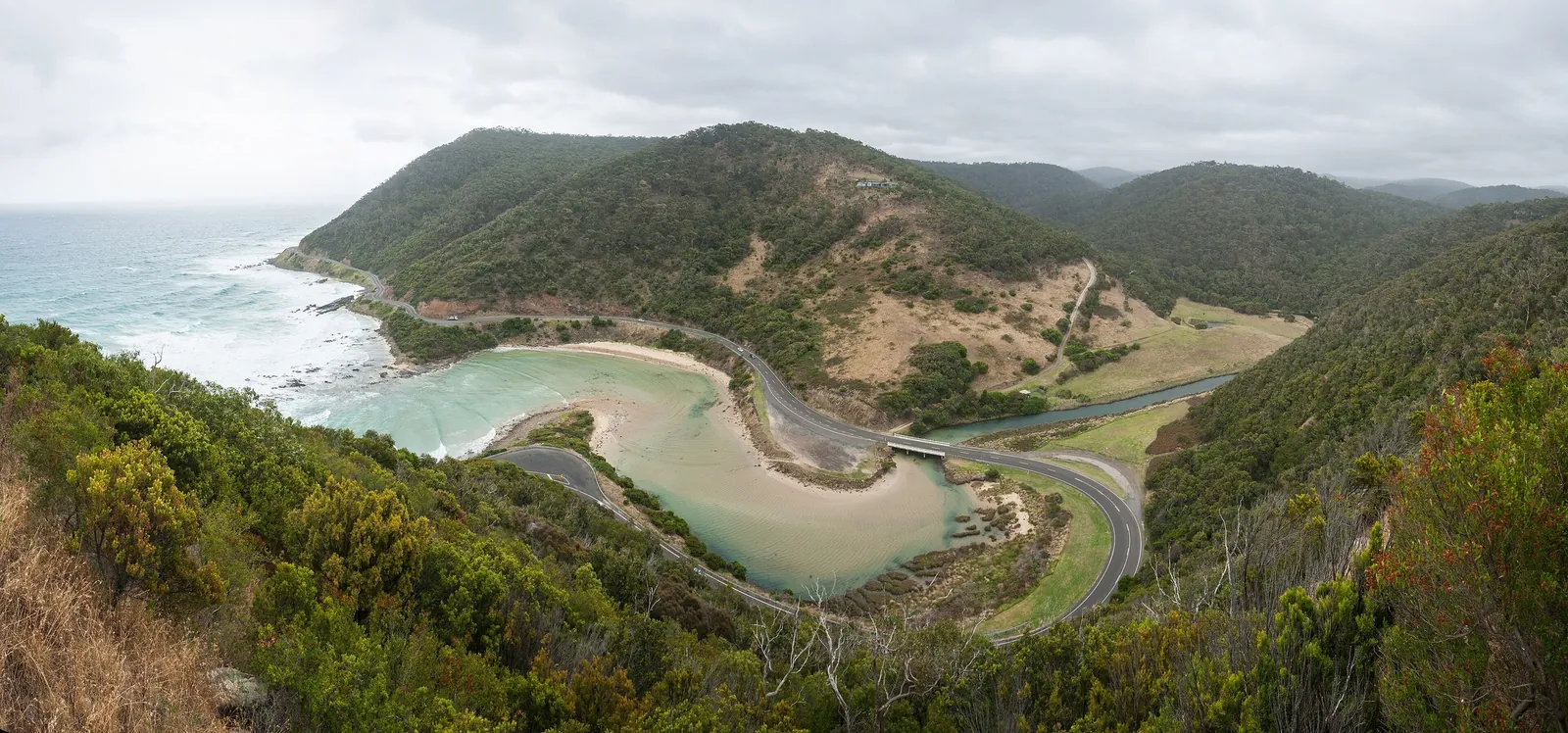 The Great Ocean Road curving around the St George River mouth, seen from Teddy's Lookout above Lorne