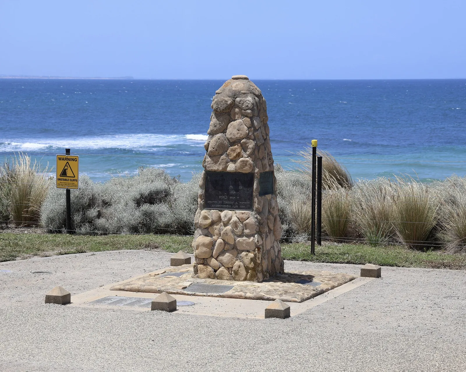 The stone war memorial at Point Danger, with the ocean behind