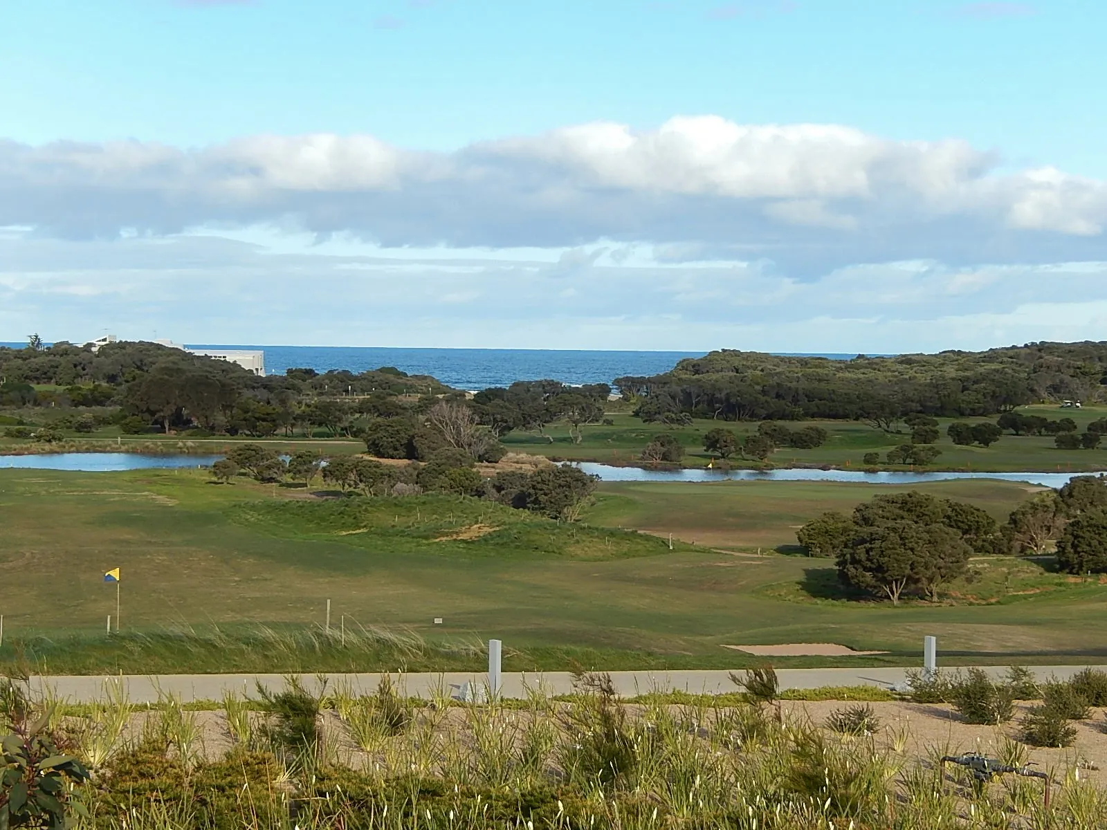The RACV Torquay golf course and its lakes, with the ocean behind