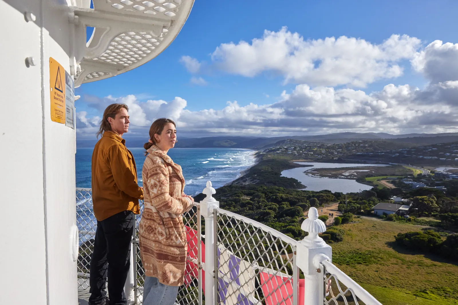 Visitors on the balcony of Split Point Lighthouse looking along the coast