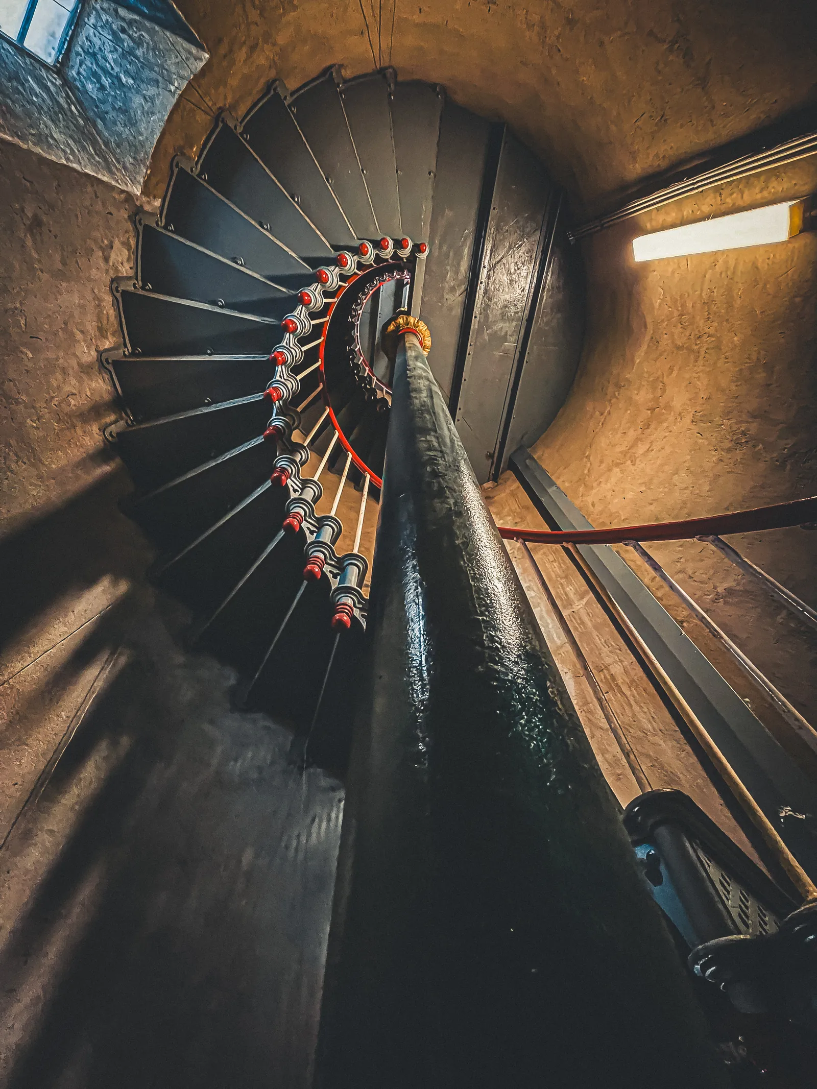 Looking up the spiral iron staircase inside Split Point Lighthouse