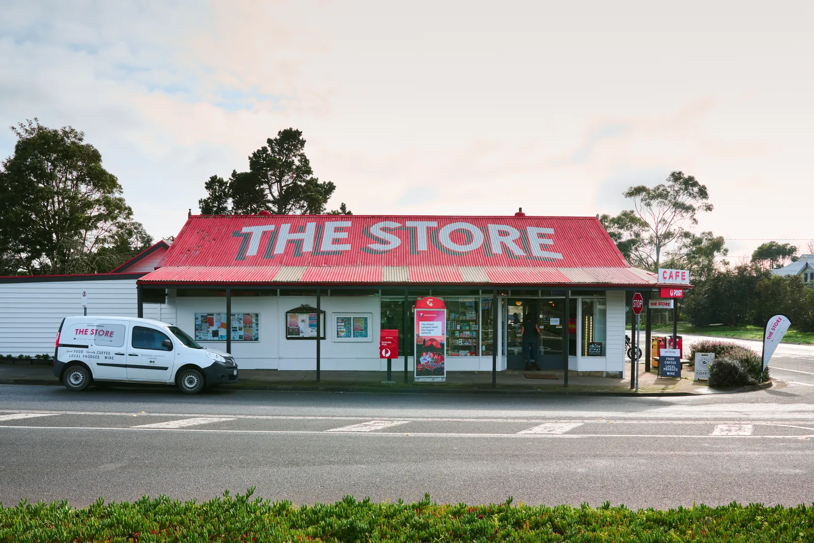 The Store in Deans Marsh from across the road, with its name painted on the red tin roof and its van out front