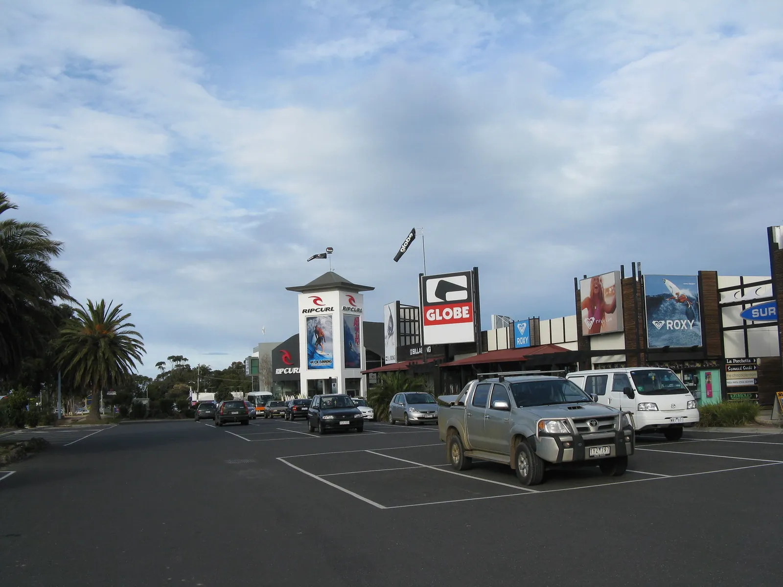 The row of surf brand stores along the Surf Coast Highway at Torquay in 2008, with Rip Curl, Globe and Quiksilver signs