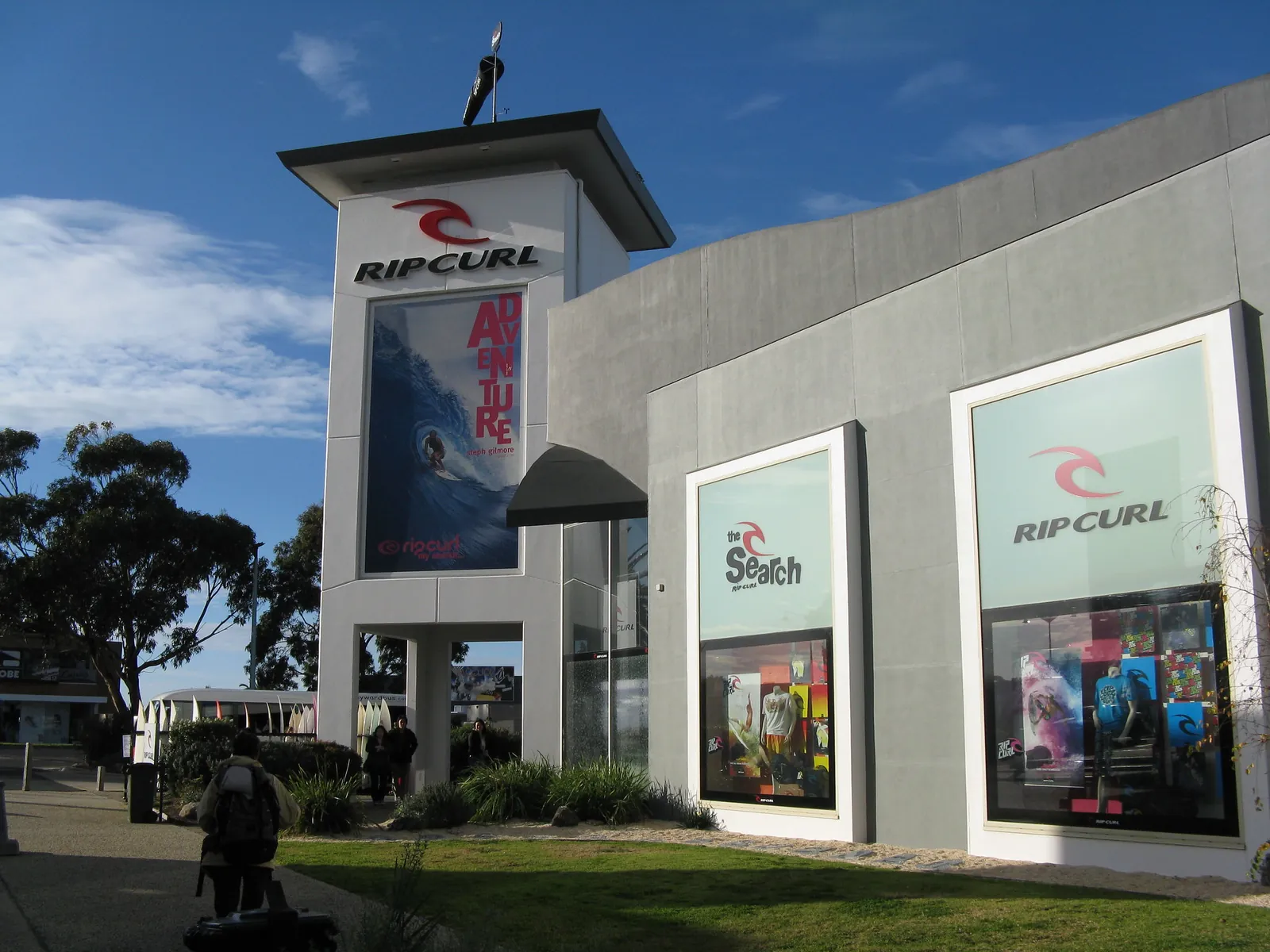 The Rip Curl store in Torquay, with its tall branded tower and window posters