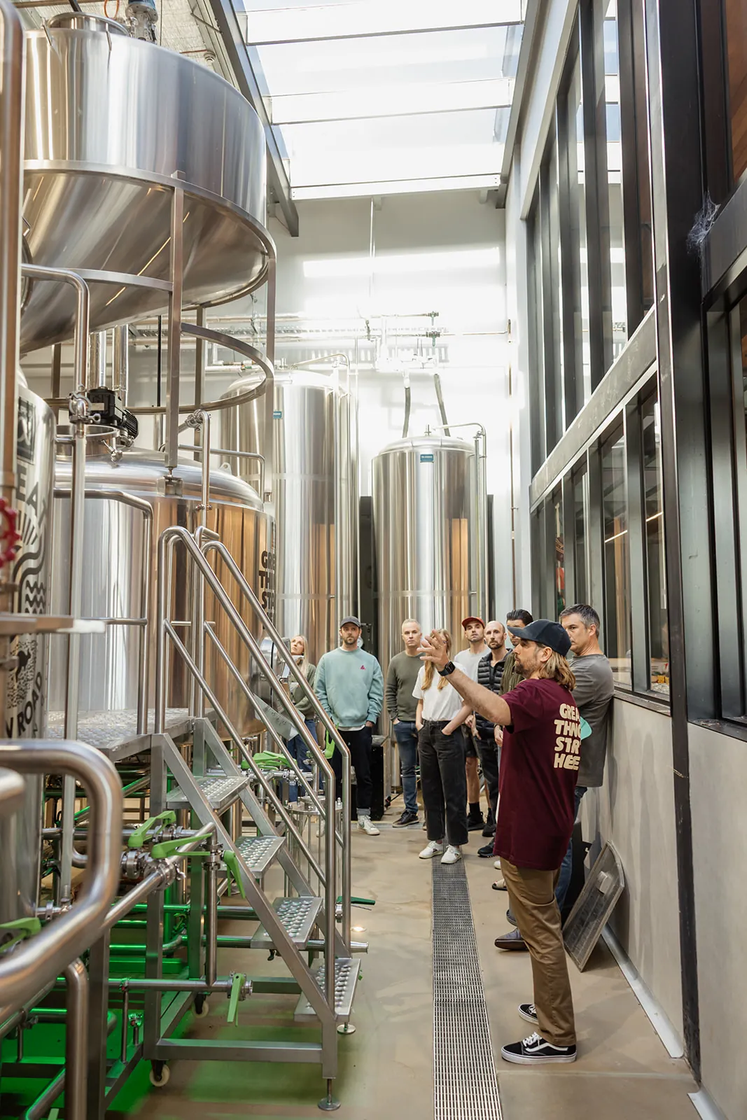 A guide leading a brewery tour between the steel tanks at the Torquay Taphouse