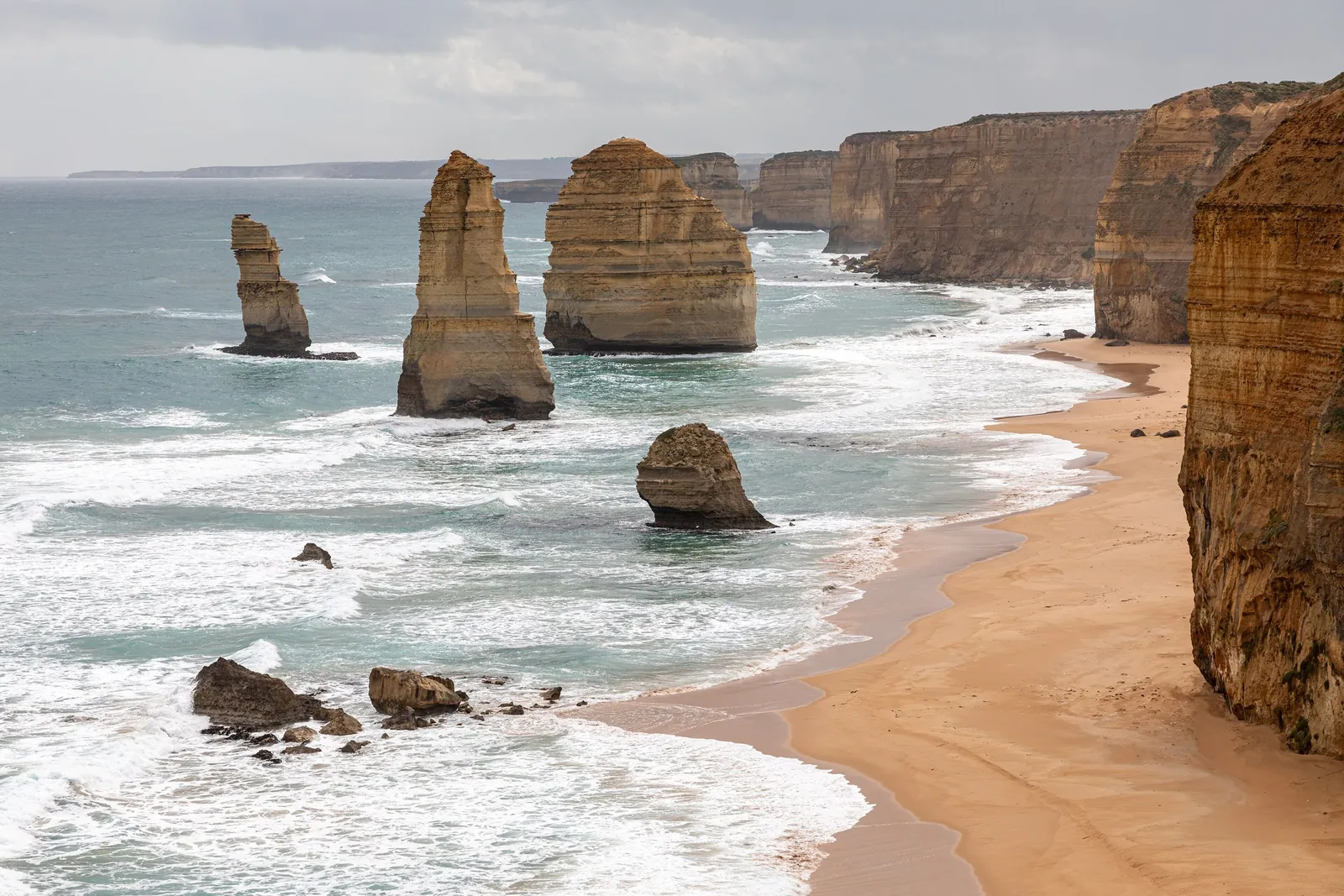 The Twelve Apostles limestone stacks rising from the surf below the cliffs of Port Campbell National Park