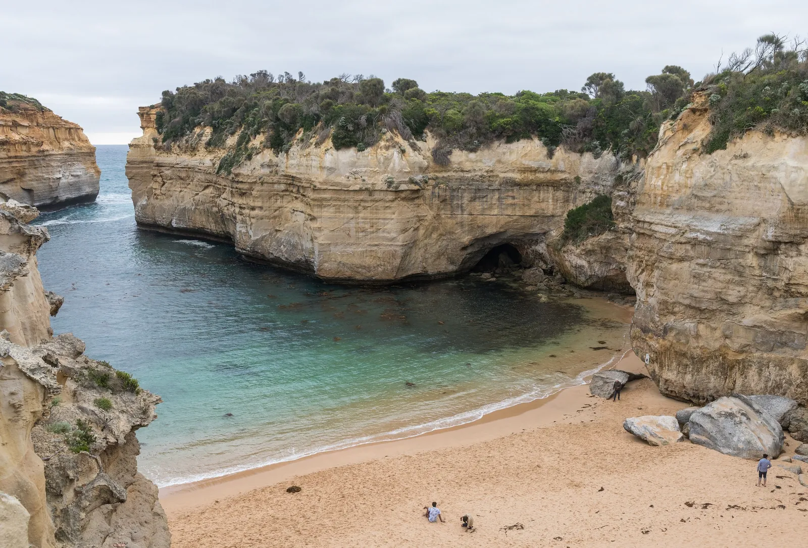 Loch Ard Gorge's sheltered beach between golden limestone cliffs