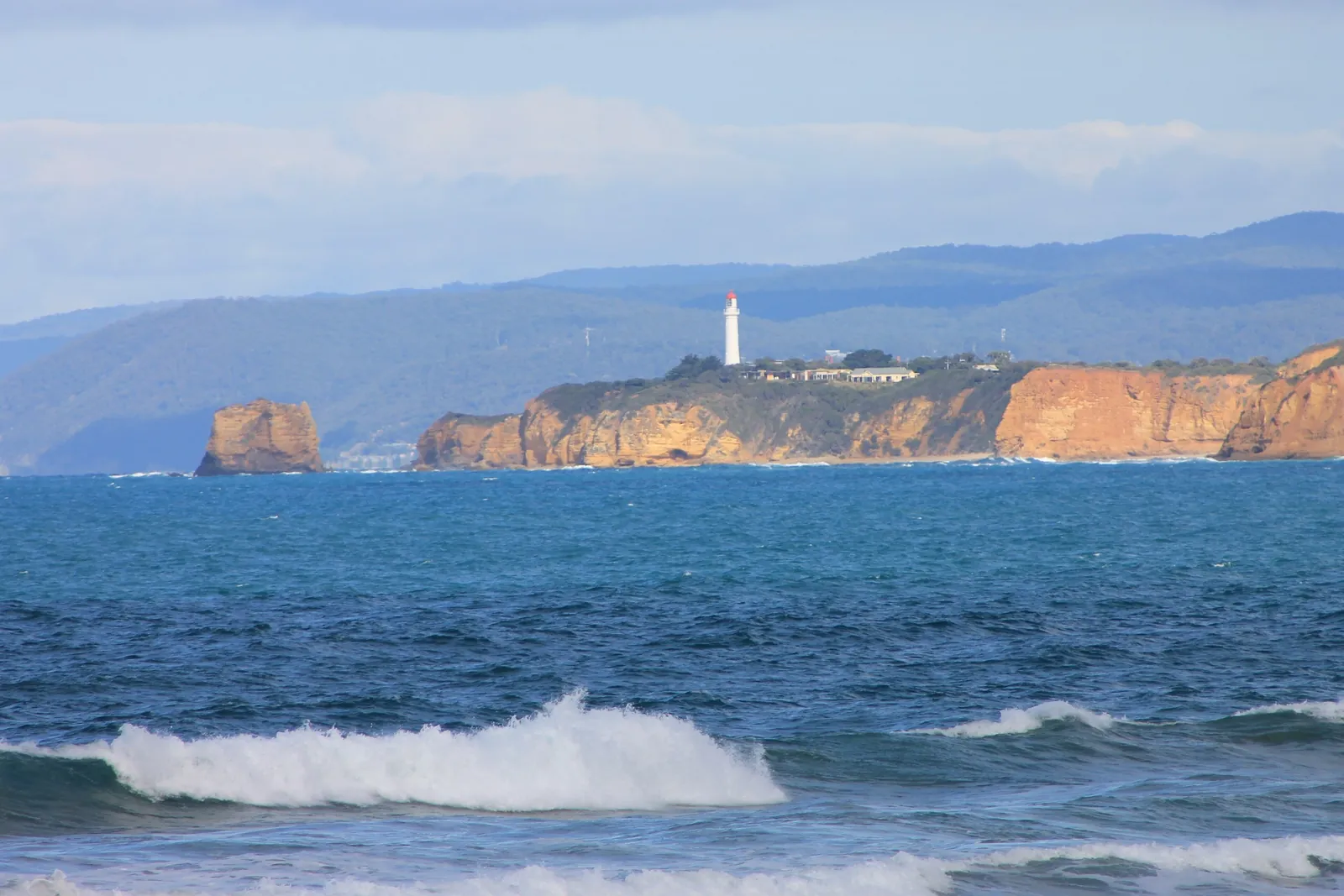 Split Point Lighthouse at Aireys Inlet on its headland, seen across the ocean from the west