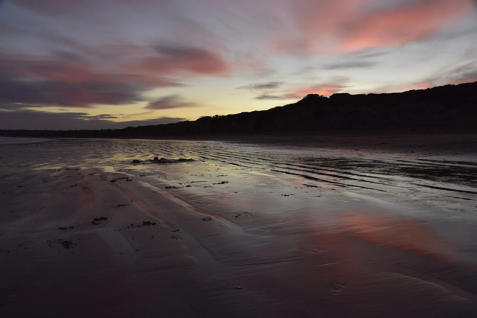 Sunset reflected on the wet sand at Whites Beach, Torquay