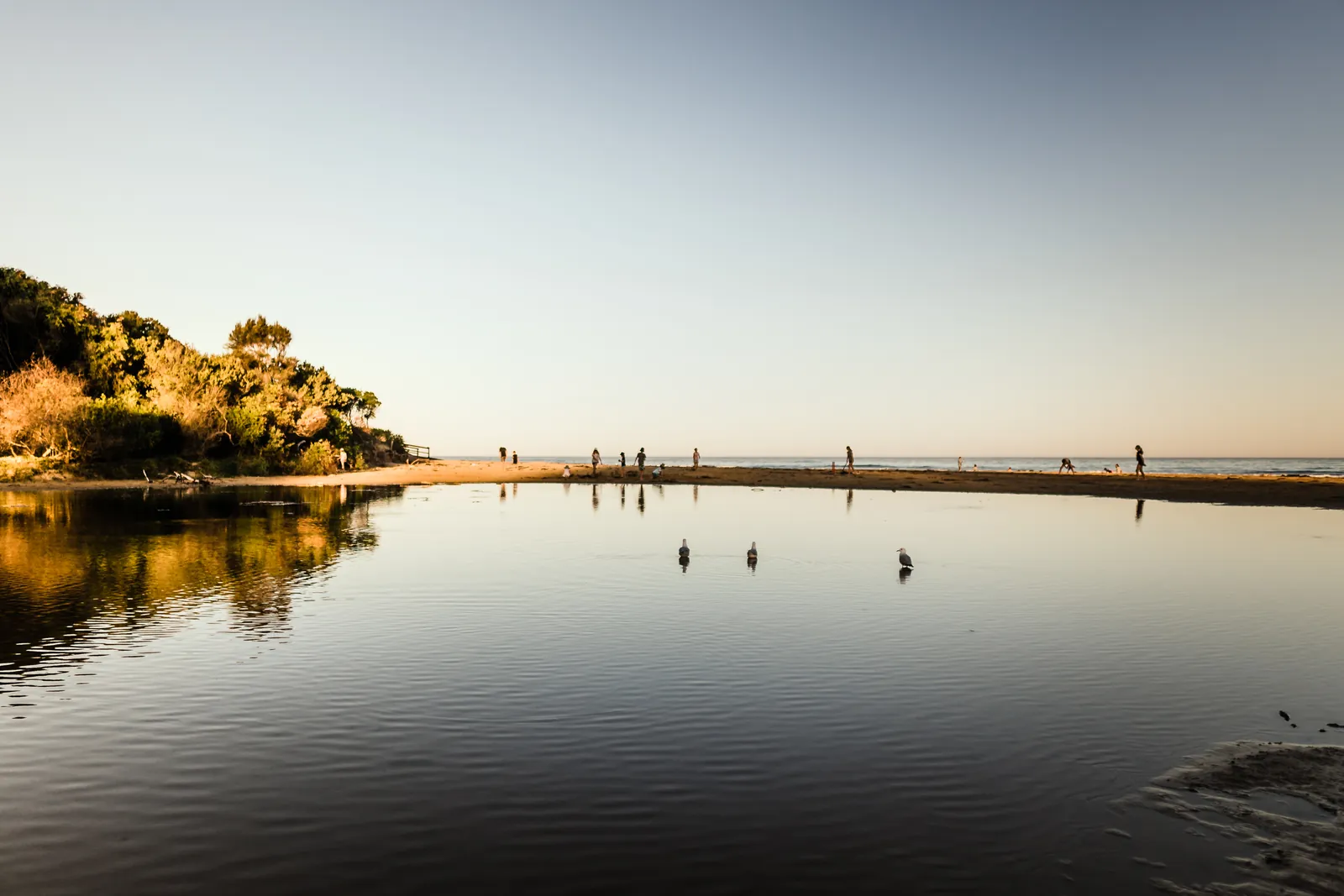 Calm water at the Wye River mouth, with the timber bridge and hills beyond
