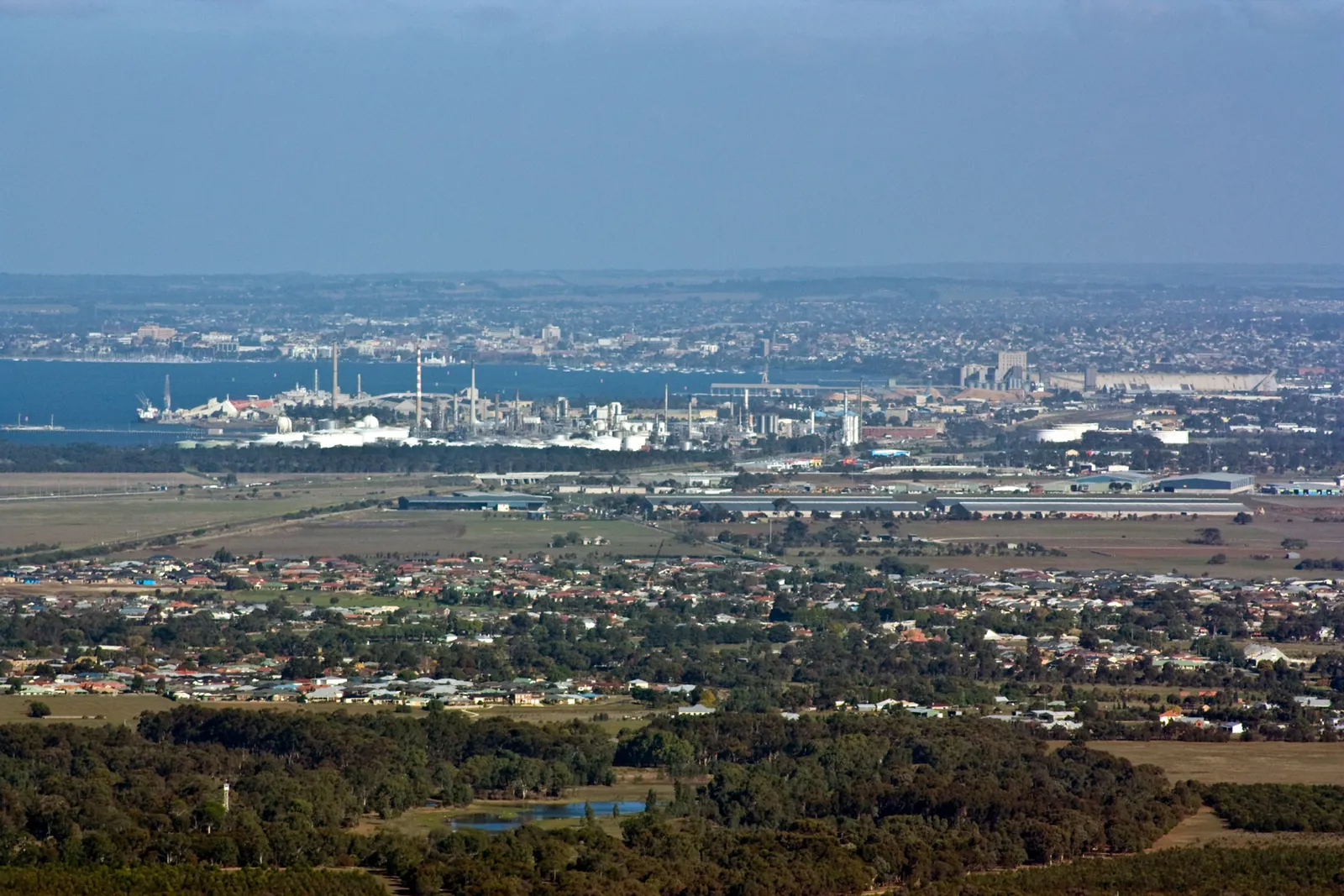 View from Flinders Peak over farmland and Lara towards Corio Bay, with Geelong's refinery and the city beyond