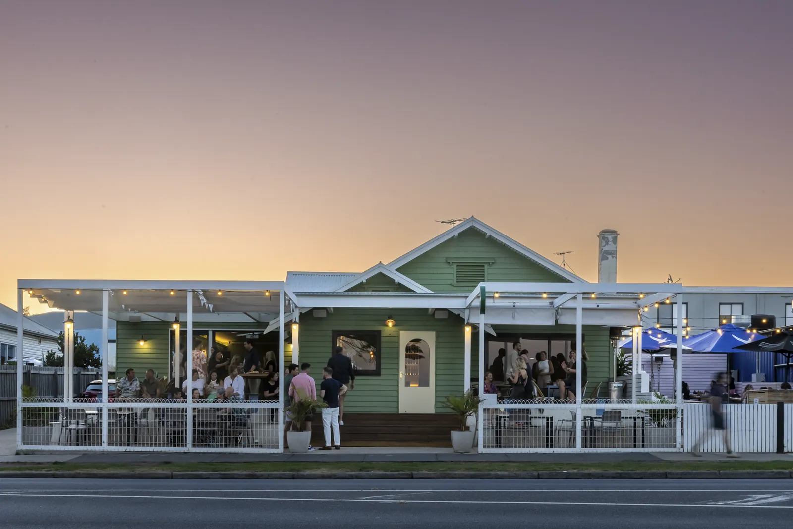Bomboras lit up at dusk, seen from across The Esplanade