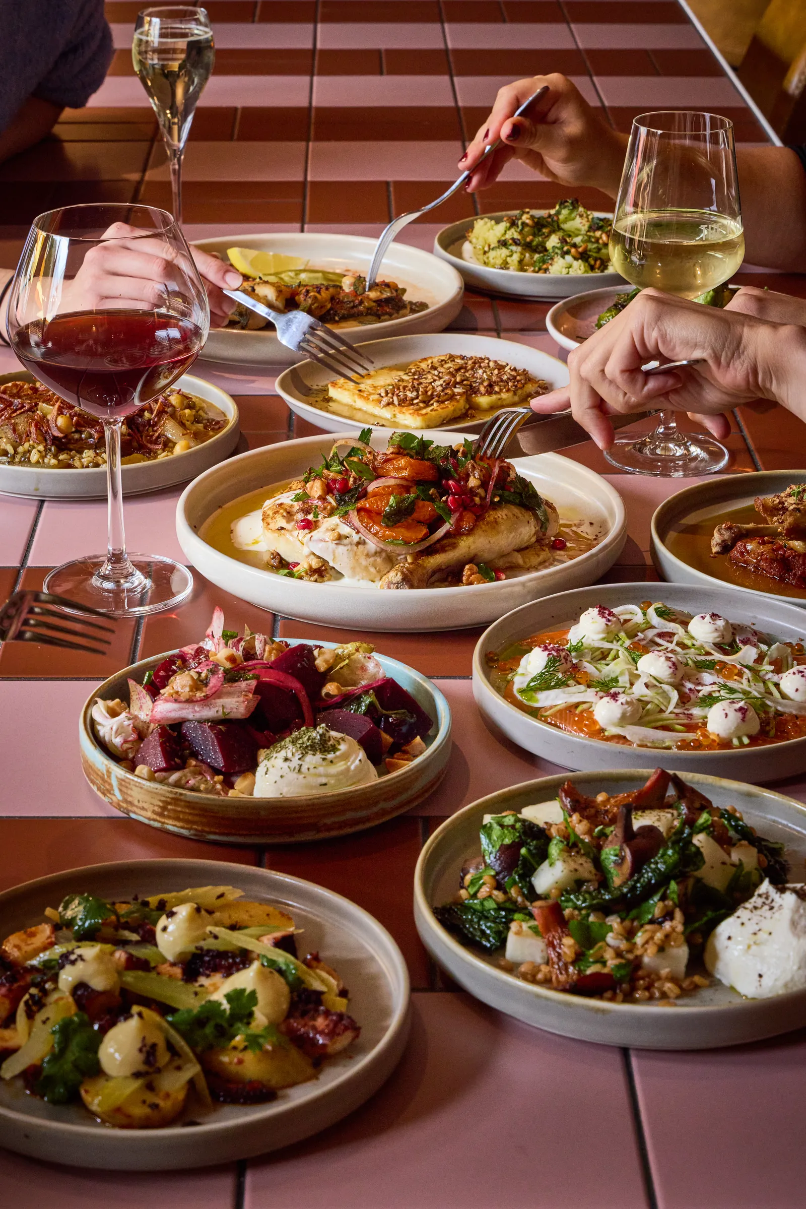 A spread of share plates with red and white wine at The Kyn