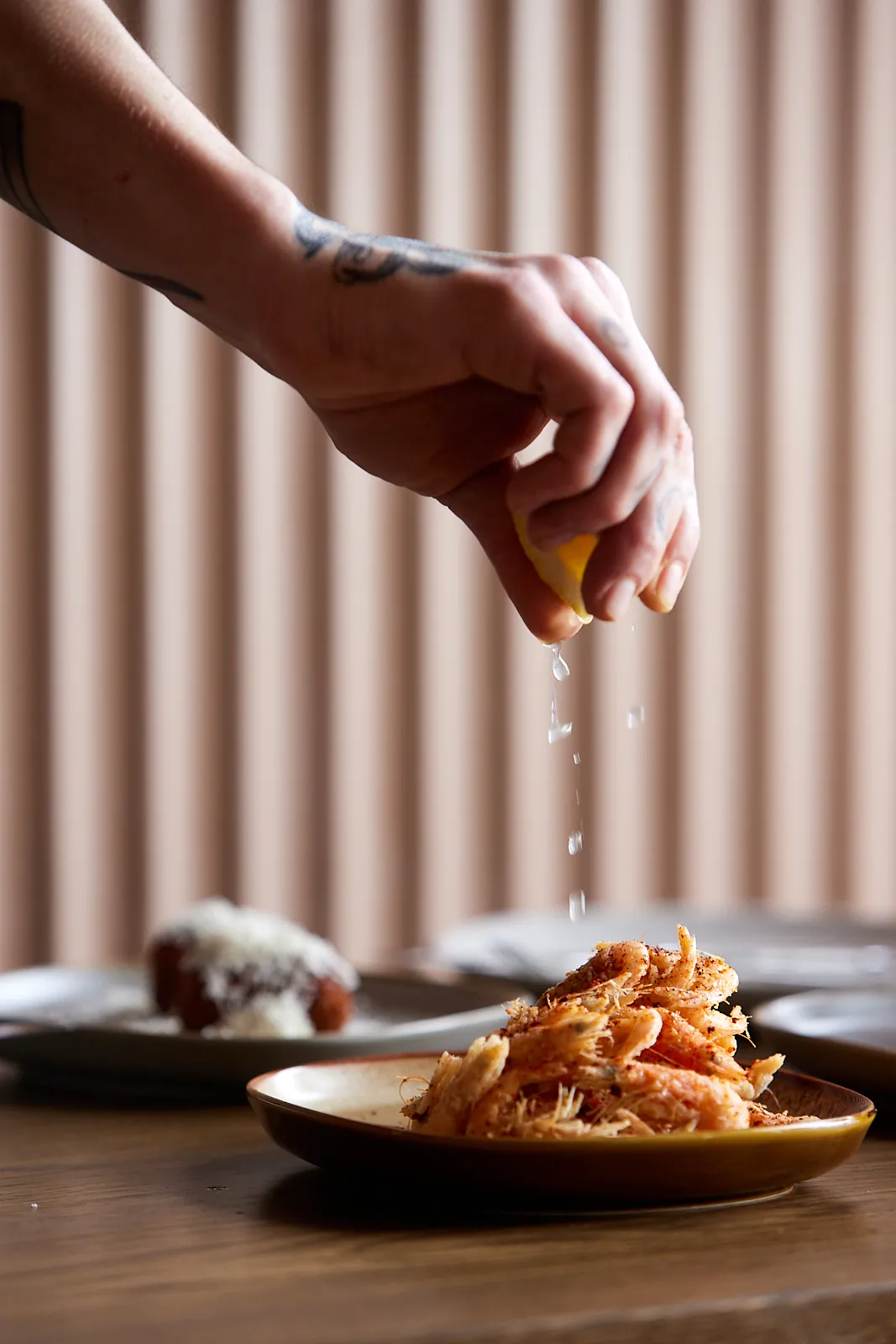 A squeeze of lemon over a small plate at The Kyn